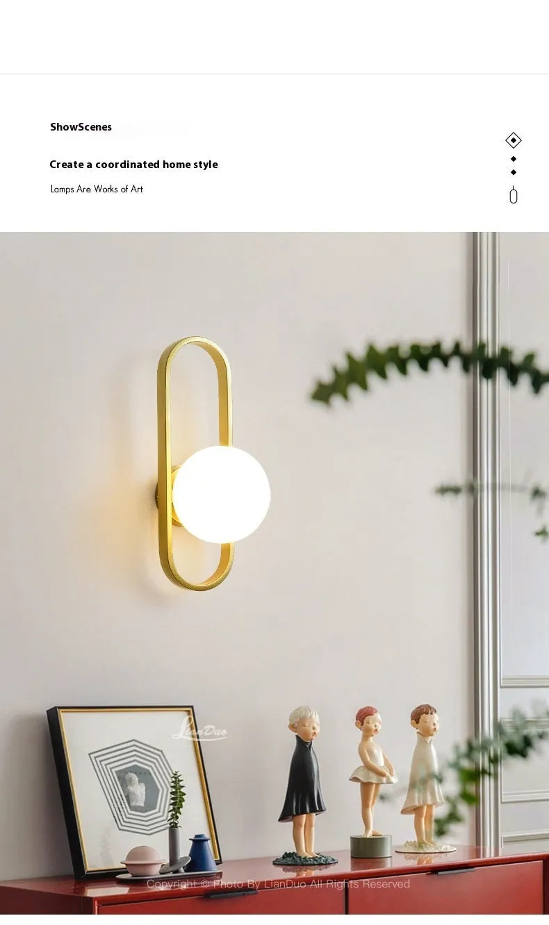 Minimalist modern wall lamp with glass shade and iron body in black finish, mounted on a wall.