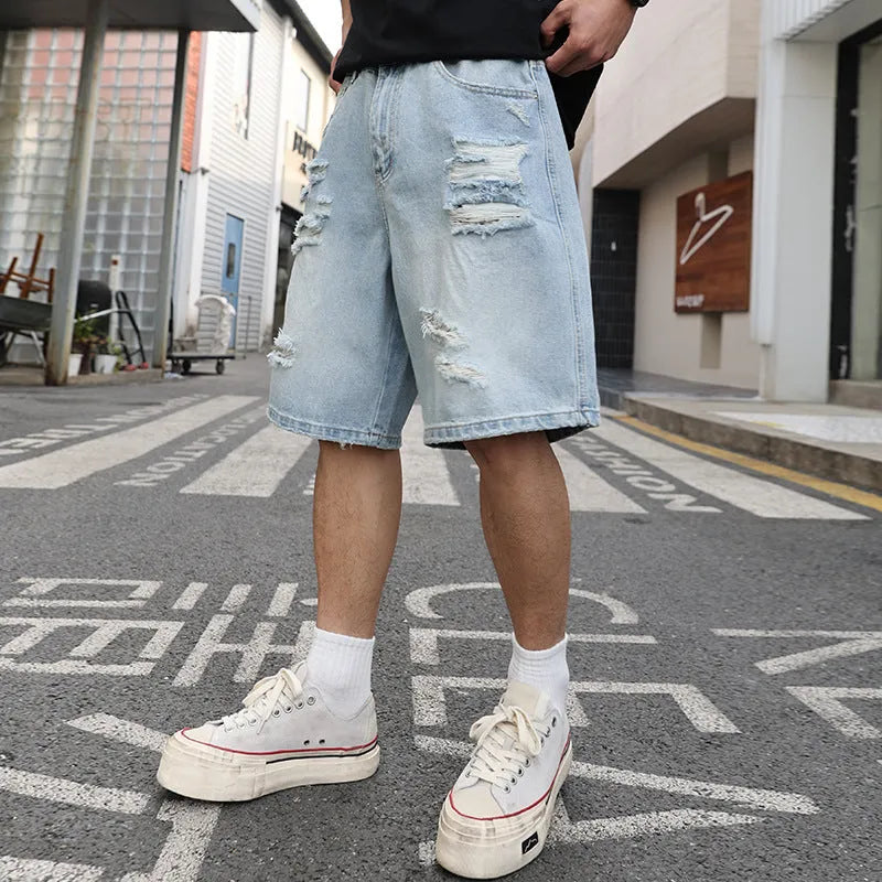 Light blue distressed denim shorts with rips and straight cut design on mannequin