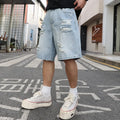 Light blue distressed denim shorts with rips and straight cut design on mannequin