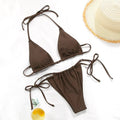 Women's polka dot print split swimsuit bikini set in polyester on a mannequin.