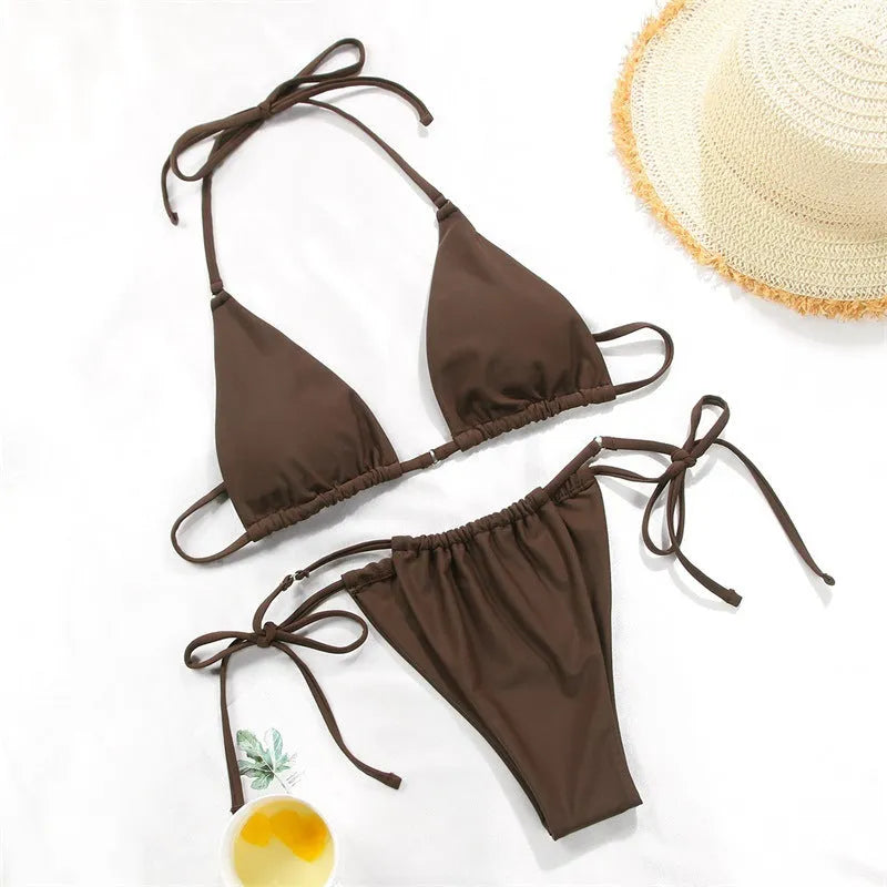 Women's polka dot print split swimsuit bikini set in polyester on a mannequin.