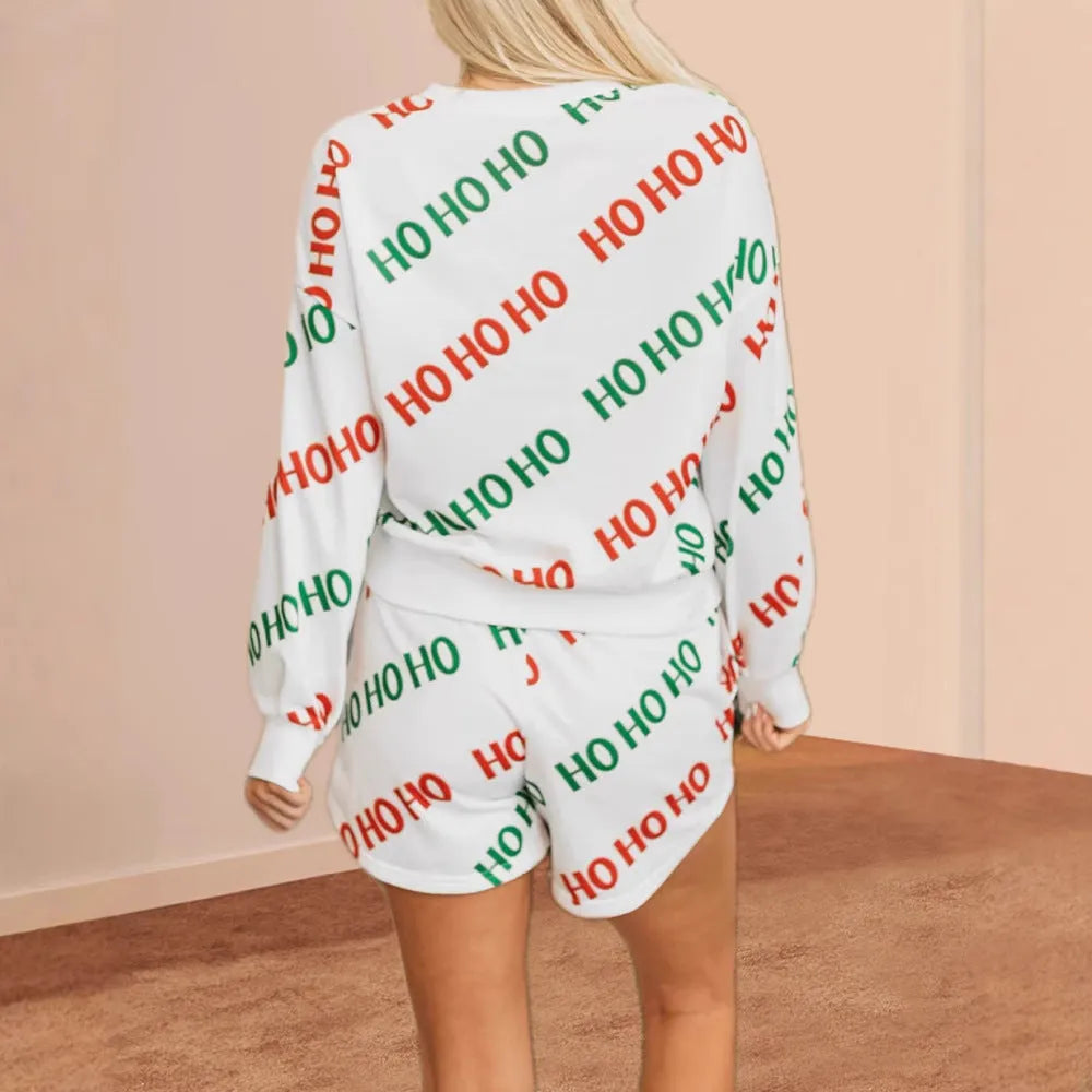 White women's two-piece suit with letters print on long-sleeved top and matching trousers.