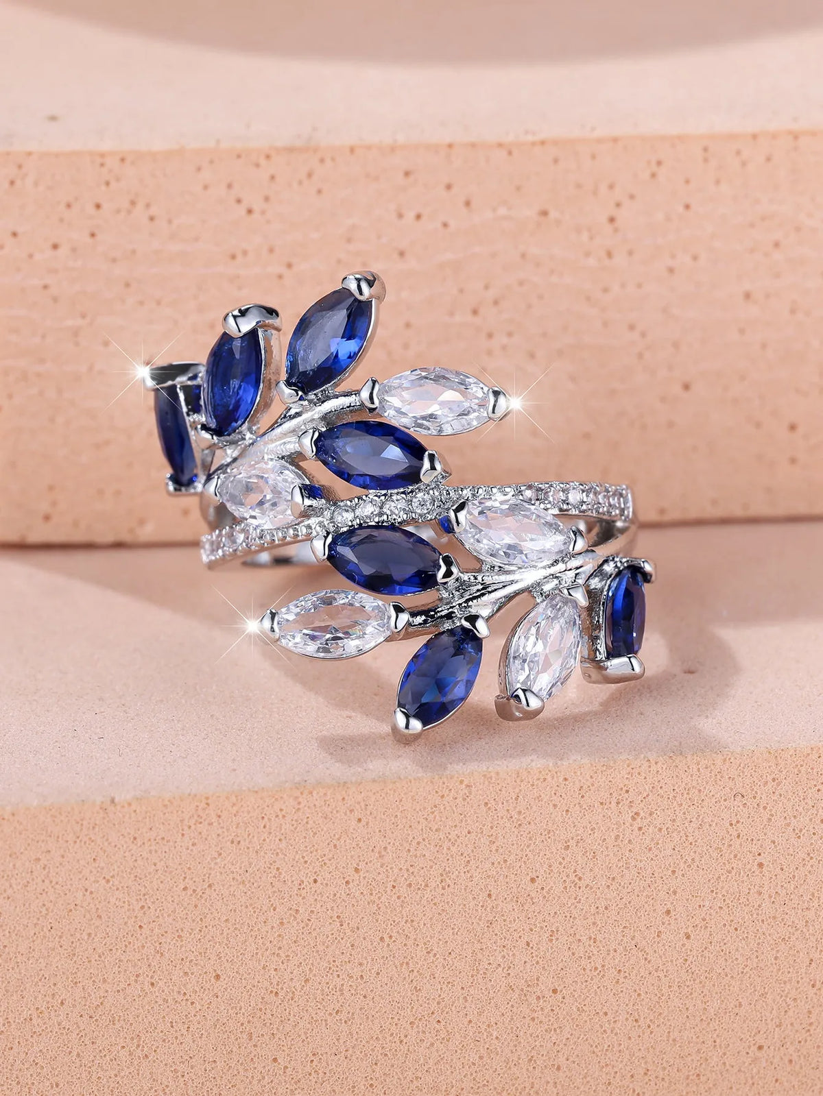 Adjustable copper leaf ring with zircon detailing in multiple colour options on display