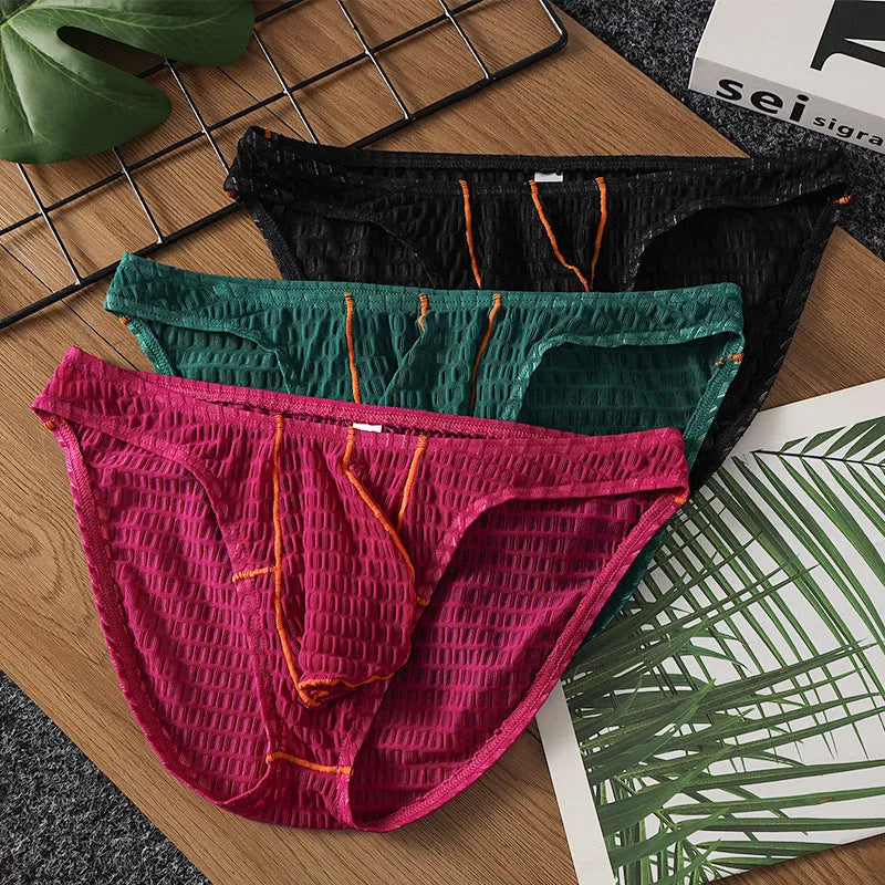 Men's low waist lace briefs in ice silk fabric on solid colour background