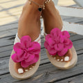 A pair of plus size floral design flip flop slippers in creamy-white with a PU upper and sole.