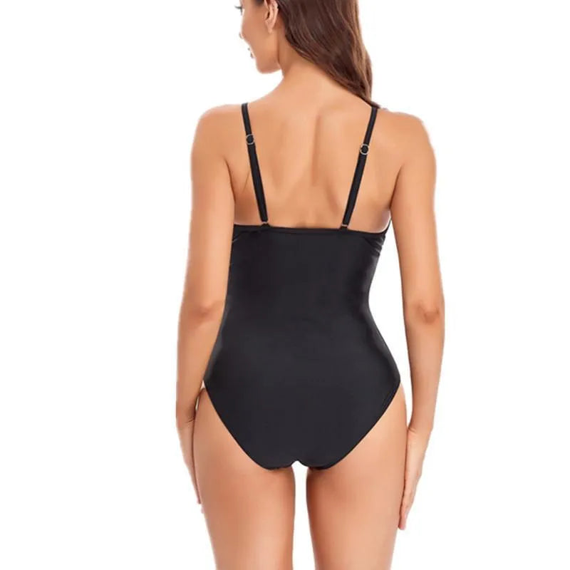 Black ladies' one-piece swimsuit with mesh sections and a backless design on a mannequin.