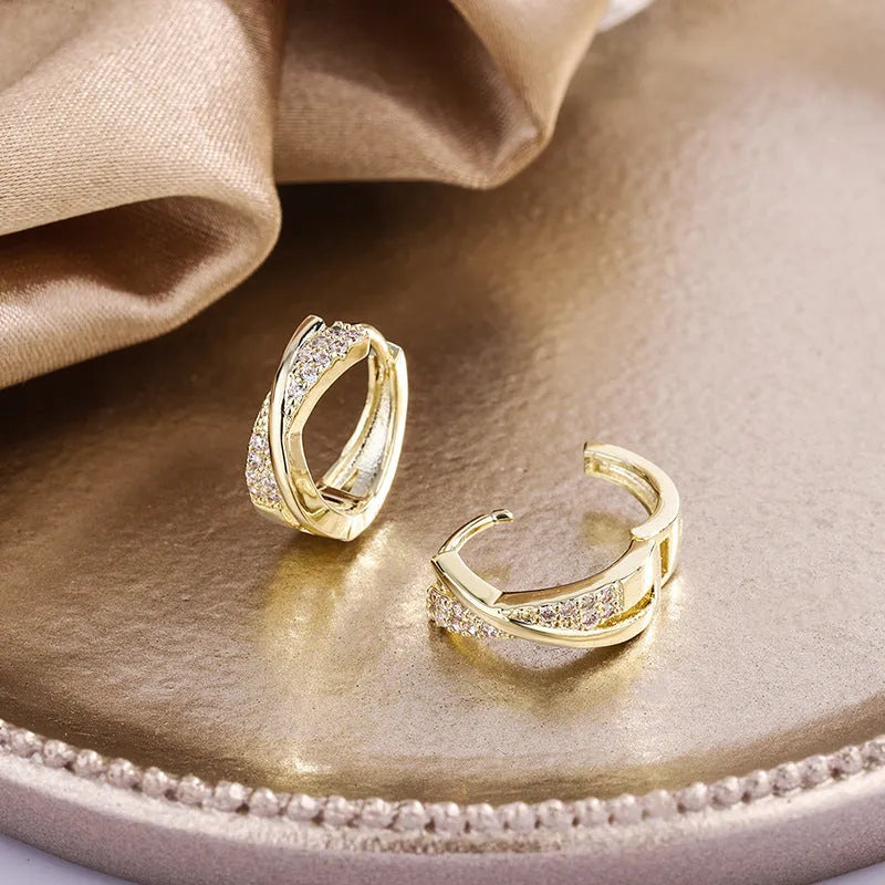 A pair of geometric drop earrings in 14K yellow gold colour, made from copper with a zircon treatment detail.