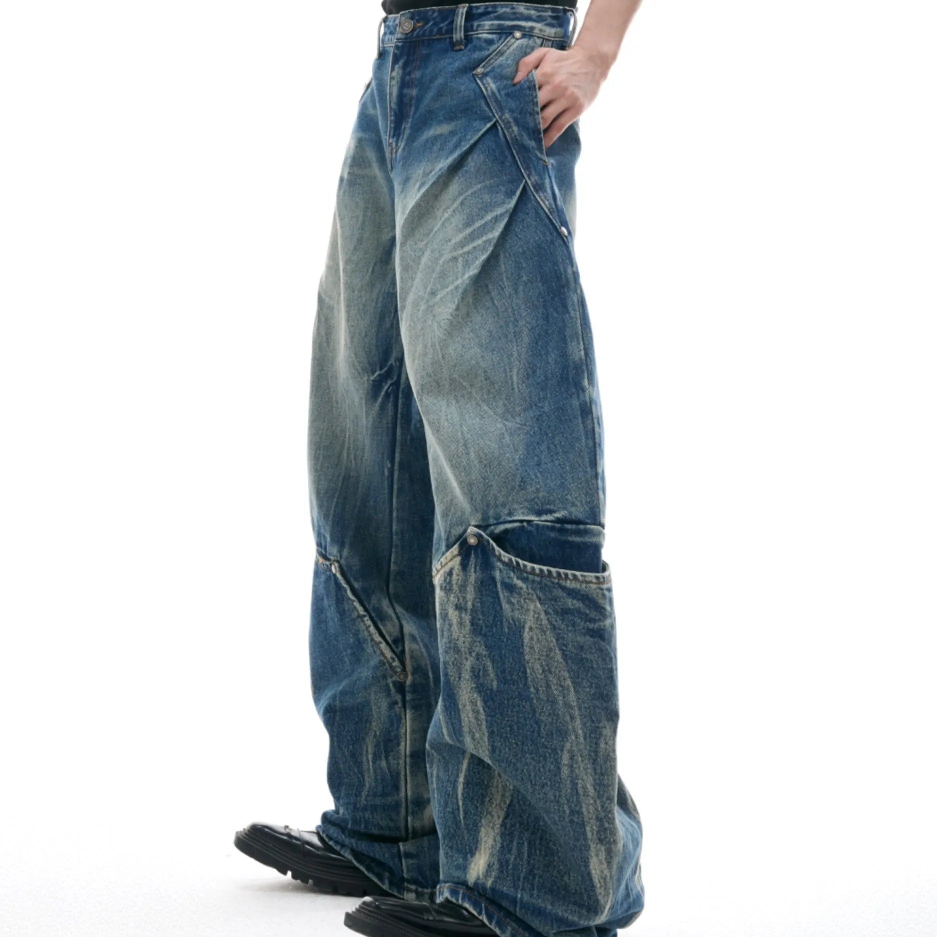 Men's verdant blue retro jeans with washed burst pattern showing curved knife fit and loose silhouette