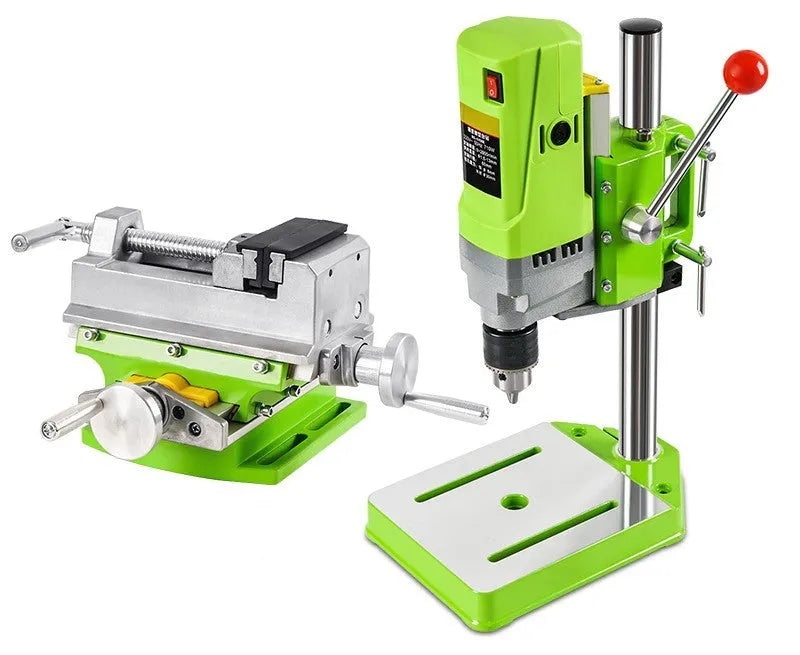 Mini bench drill and milling machine on a workbench with cross bench pliers.