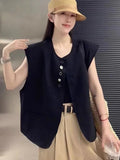 Women's solid colour polyester vest with pockets in loose fit and short 40cm length.