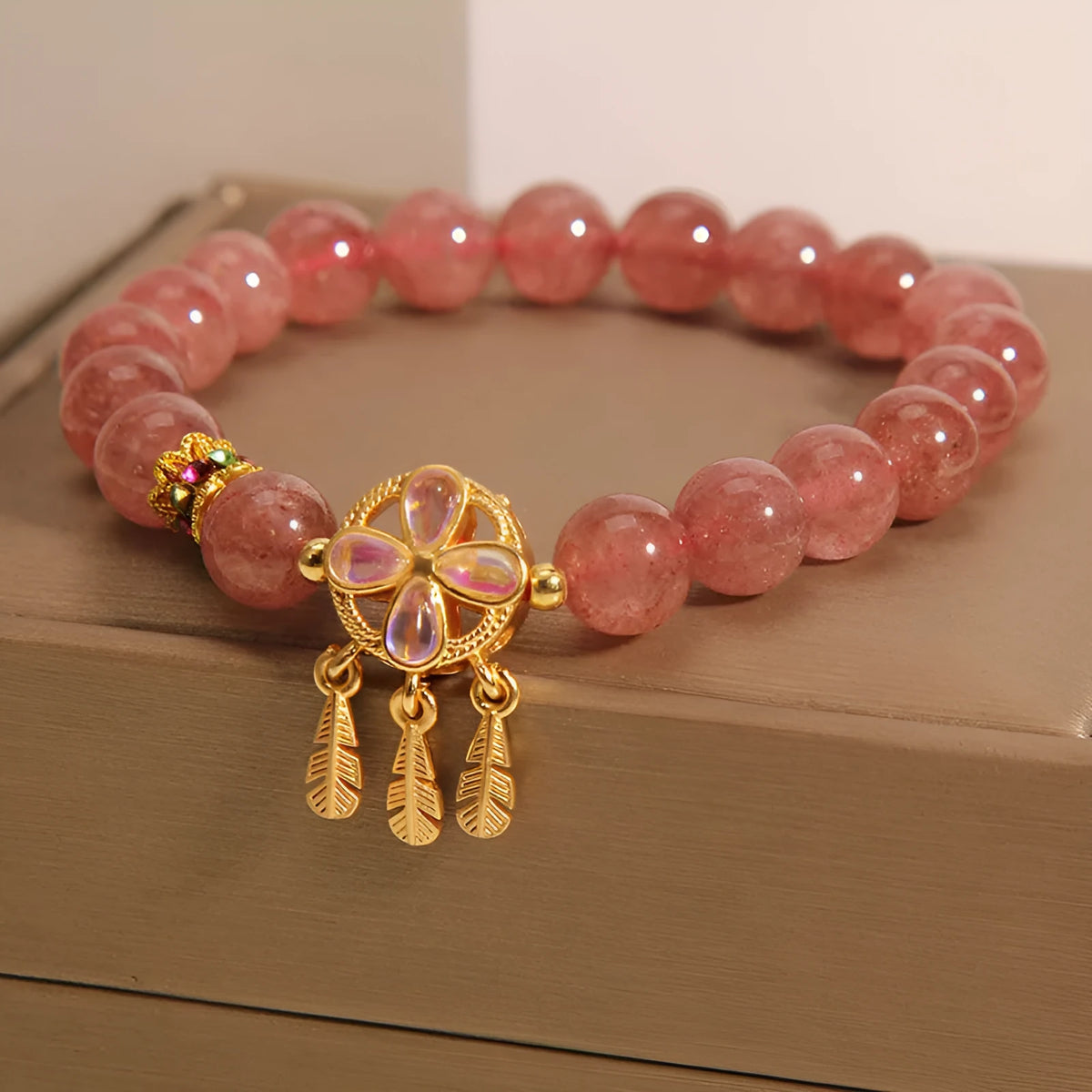Women's strawberry quartz crystal bracelet with four-leaf dream catcher ball pendant
