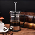 Glass French press coffee maker with stainless steel plunger showing 350ml capacity markings