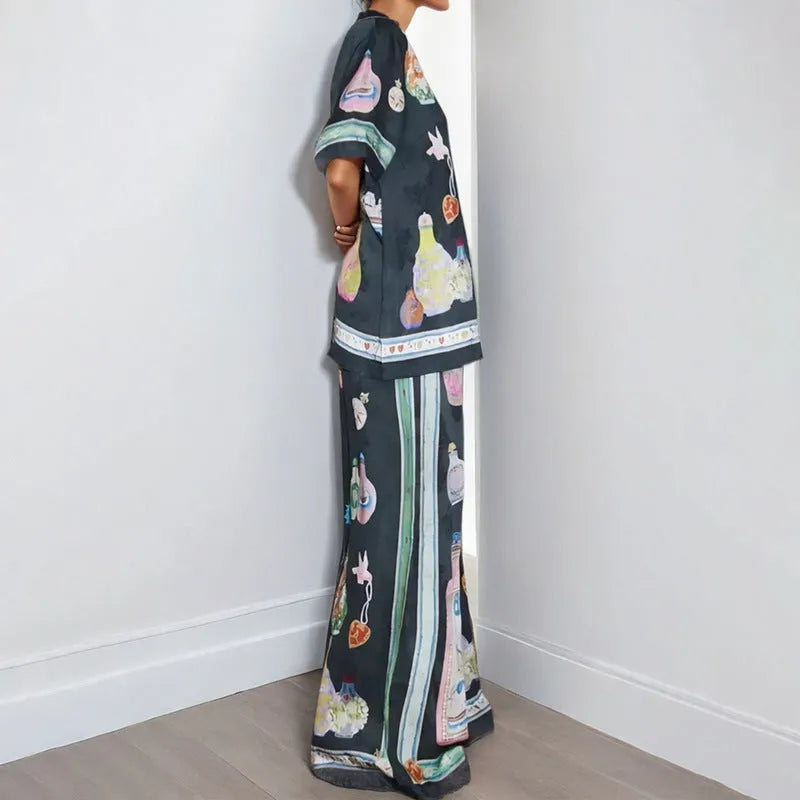 Women's black polyester co-ord set with cartoon animation print showing cardigan and trousers