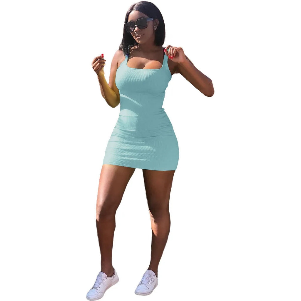Woman wearing a slim fit casual dress with a big U-neck, sunken stripe straps, and princess sleeves.