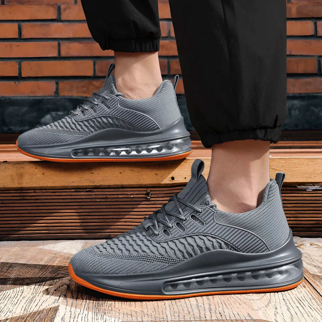 Men's low-top black mesh running sneakers with rubber sole and lace-up front, shown on a white background.