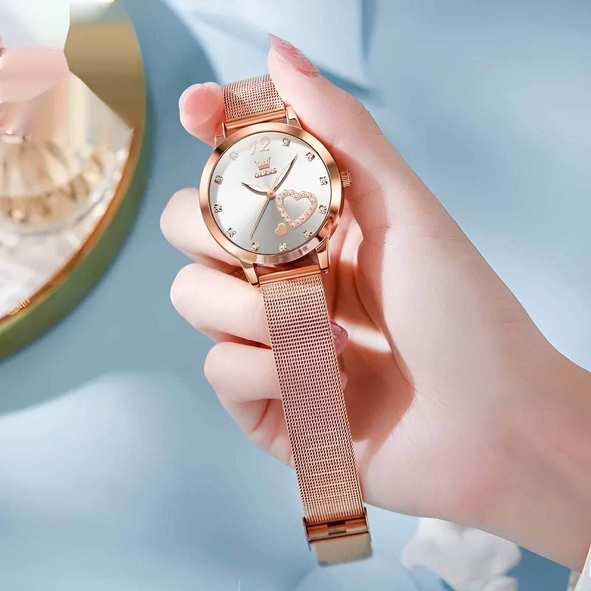 Women's fashion watch with a mesh strap and rose gold-tone alloy case, showing dial colour options: white, black, blue, red, pink, and green.