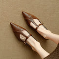 Brown pointed low-cut women's flat shoes with round toe and metal decoration on cowhide upper.