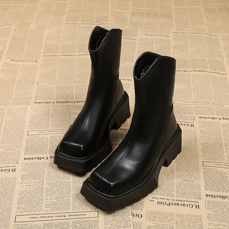Women's black platform Martin boots with square toe, chunky sole, back zipper, and block heel.