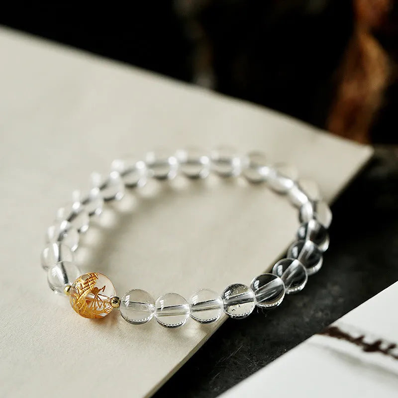 Geometric obsidian black agate white crystal bead bracelet with gold dragon charm on wrist