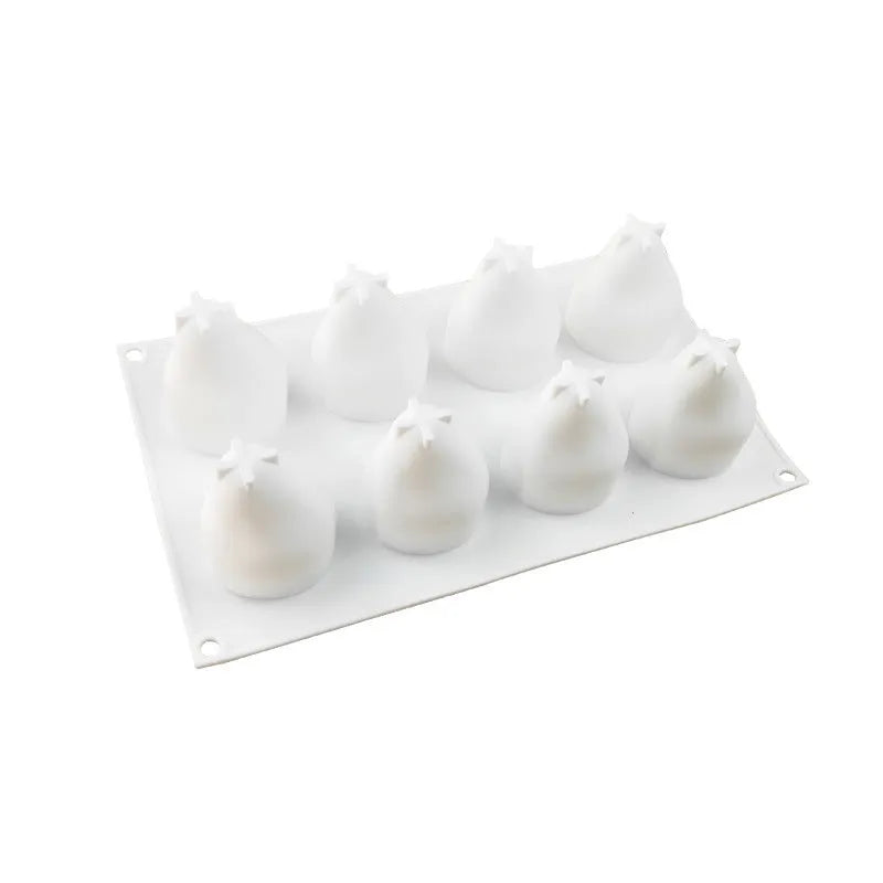 Silicone baking mould with six pineapple and pine cone shapes for making decorative desserts.