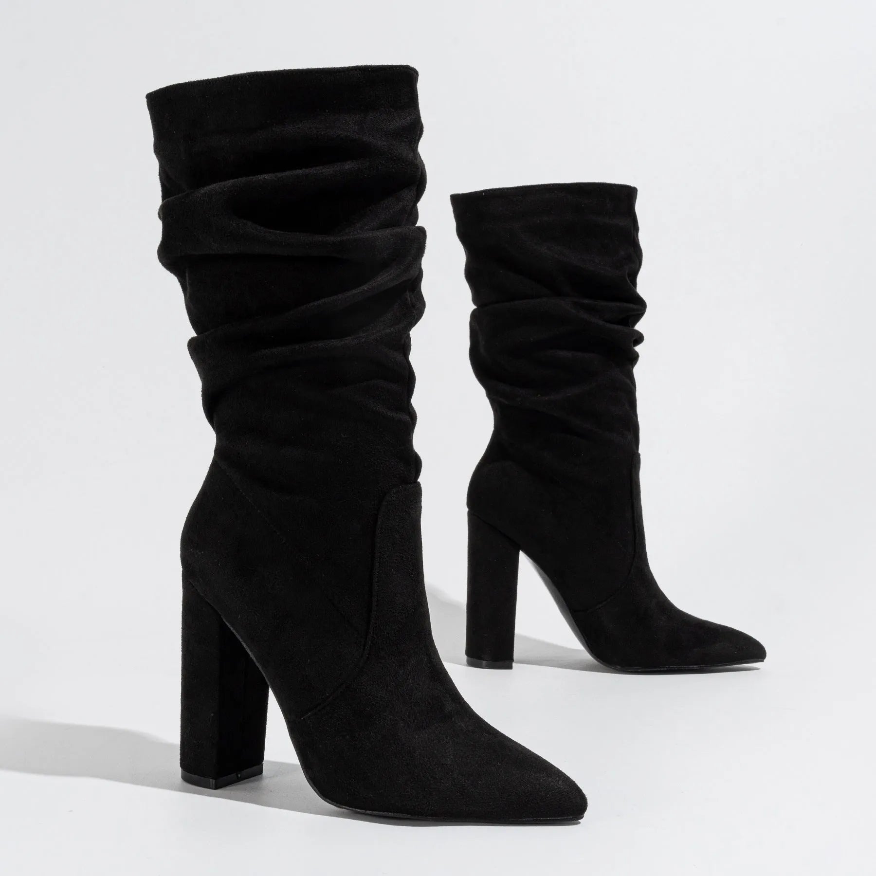Women's black suede boots with chunky high heels and pointed toe design