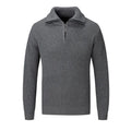 A man's loose-fitting slim pullover jumper in a solid colour, shown in a casual setting.