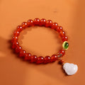 Handmade red agate bracelet with geometric Chinese design featuring Maitreya Buddha jade pendant and ancient gold elements