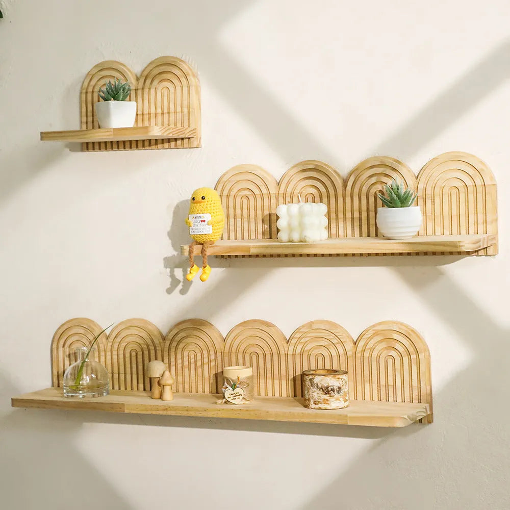 Solid wood multi-layer wall-mounted shelf holding several small potted plants.