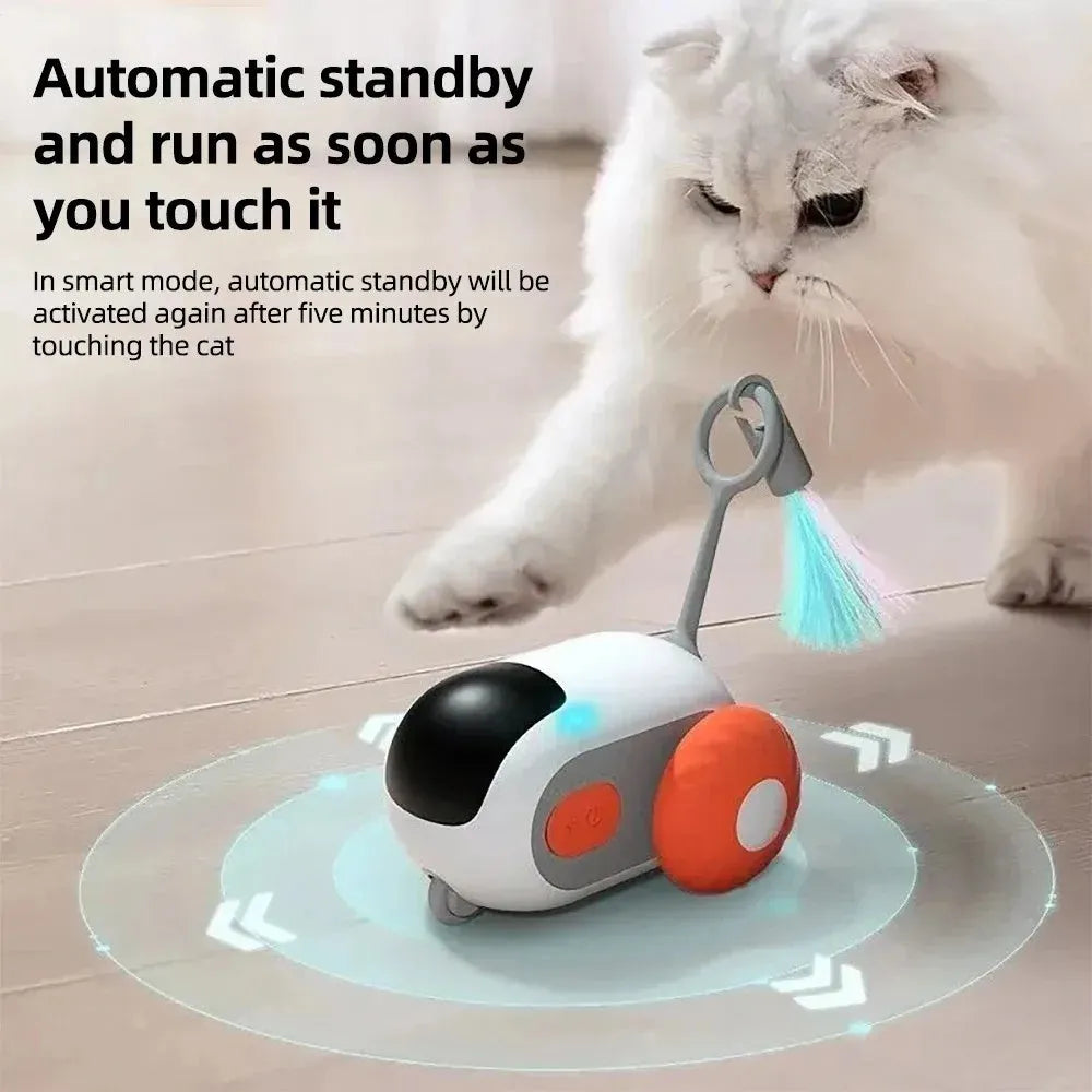 Blue smart cat toy car with feather teaser attachment and remote control unit on floor