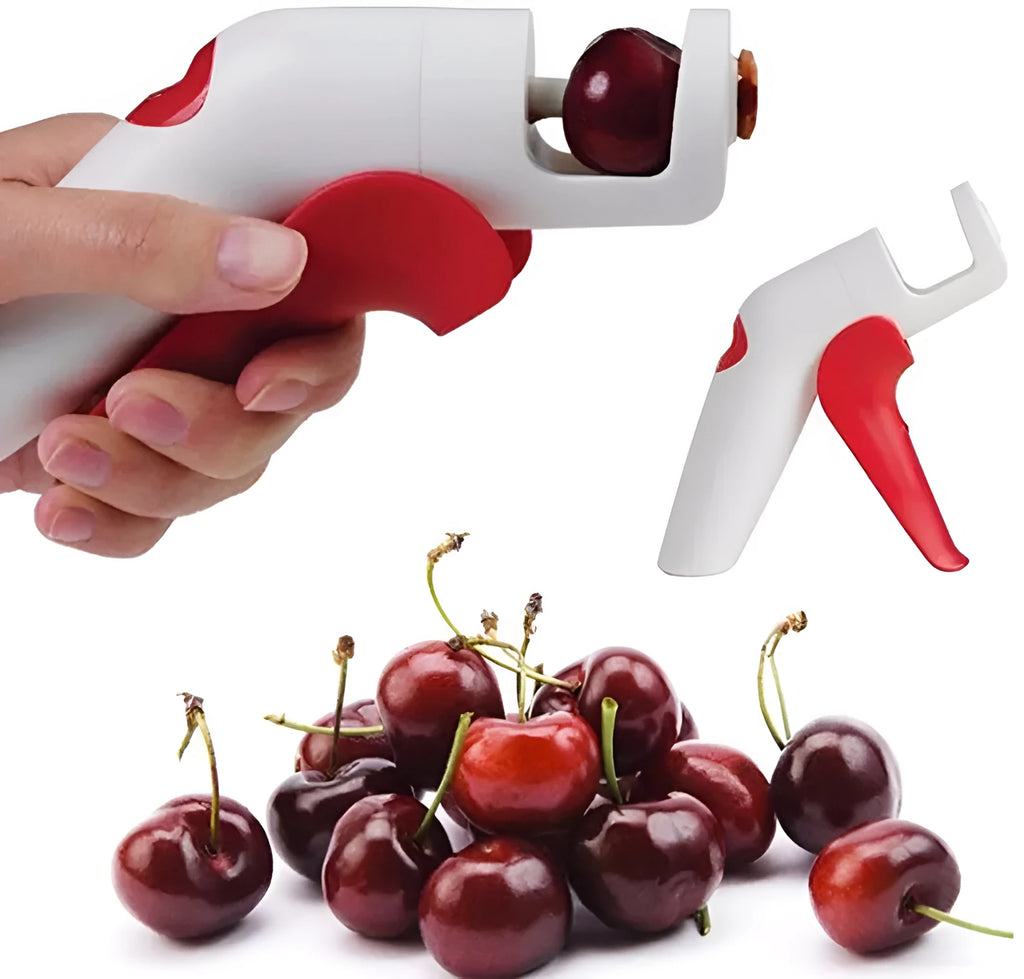 Stainless steel manual cherry kernel remover tool on a kitchen worktop.