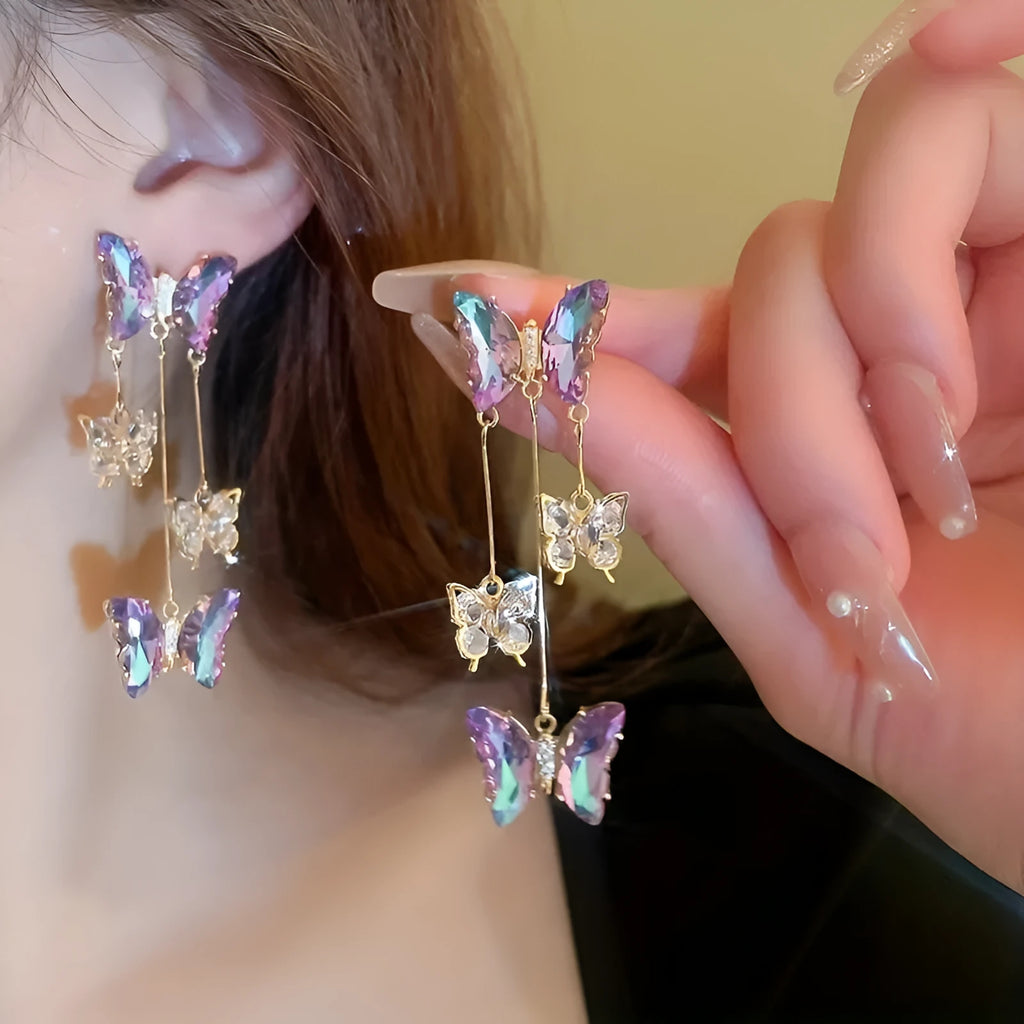 Silver needle blue purple butterfly tassel drop earrings with crystal flower details on alloy.