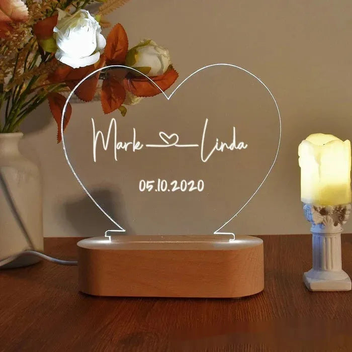 Custom couple names and date engraved on a transparent acrylic LED night light.