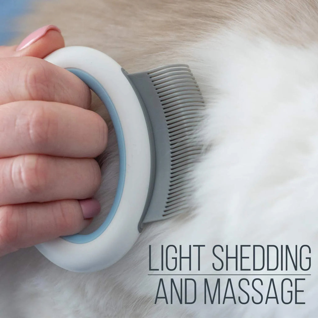 Blue pet grooming comb for deshedding and dematting cat and dog hair on a white background.