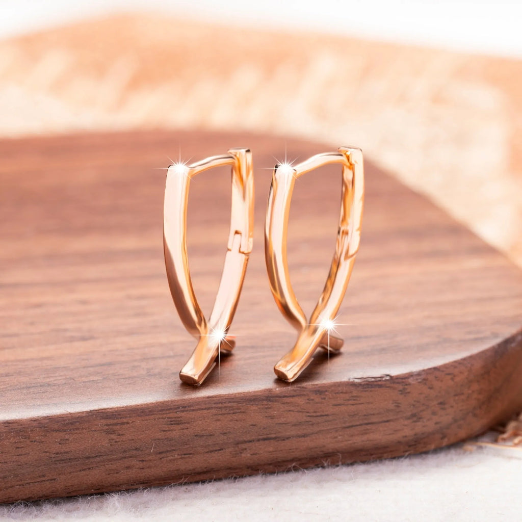 Rose gold cross shaped copper earrings with minimalist design and light luxury finish