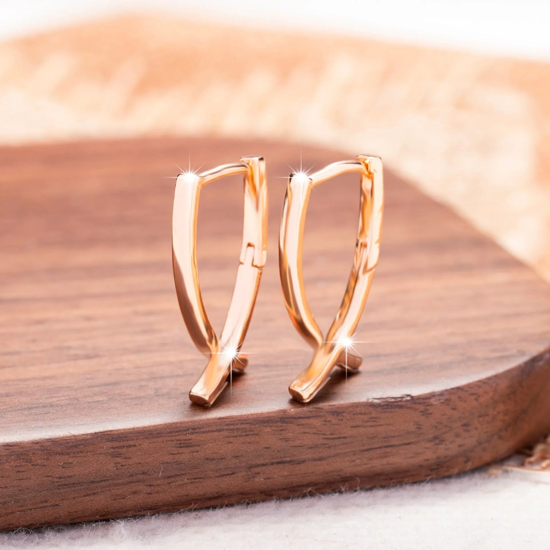 Rose gold cross shaped copper earrings with minimalist design and light luxury finish