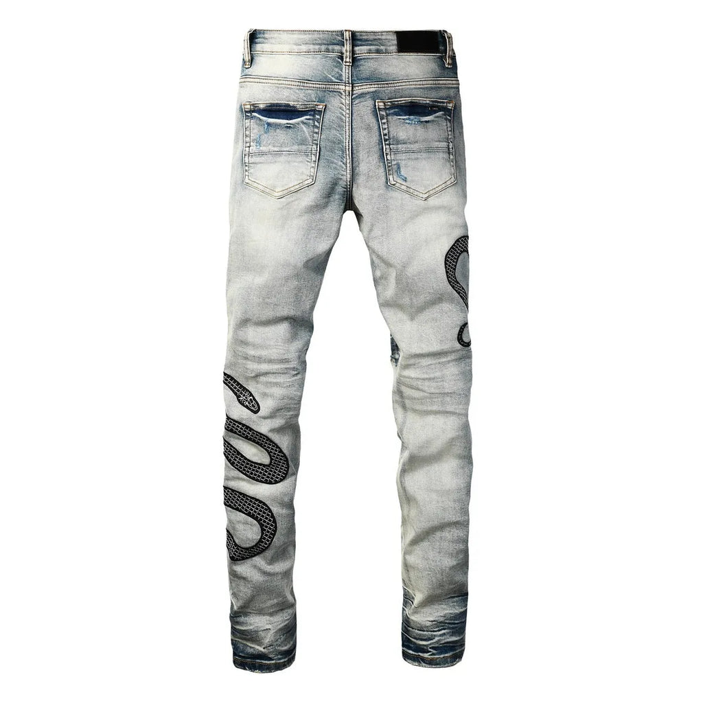Men's blue distressed skinny jeans with wash finish showing button fly and slim fit
