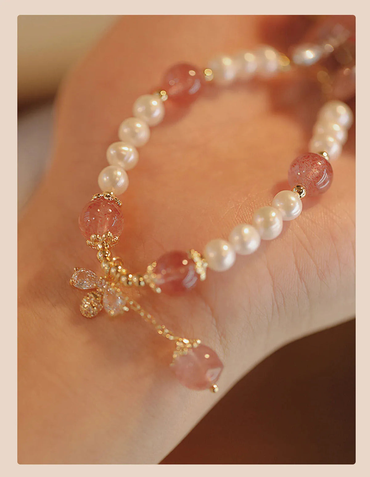 Strawberry quartz crystal bracelet with stringed pearls and bow detail