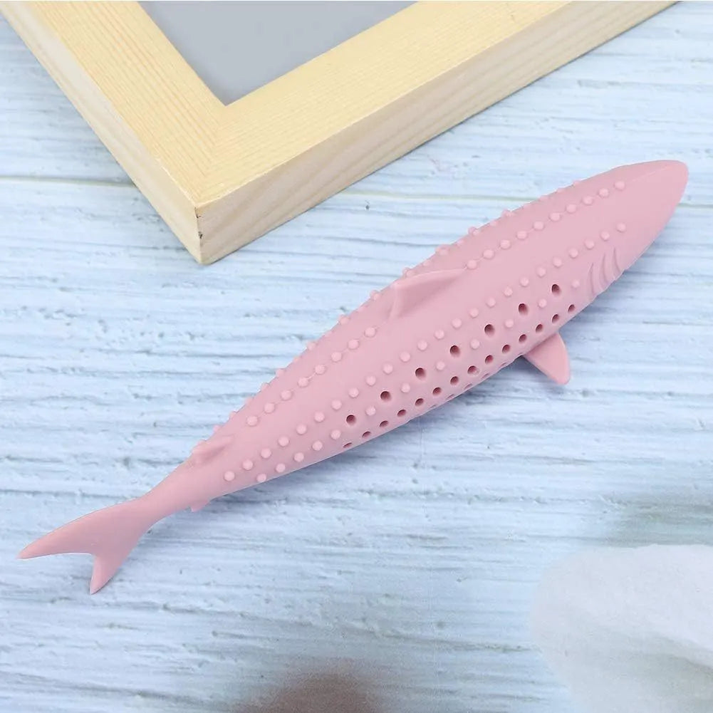 Green silicone fish-shaped cat chew toy with dolphin details and visible side holes.