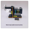 Steel alloy watch strap removal tool with spring mechanism on a work surface