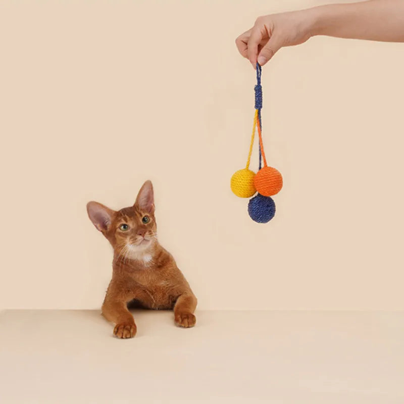 Bite-resistant cat teaser stick with wire core and three attached colourful catnip balls.