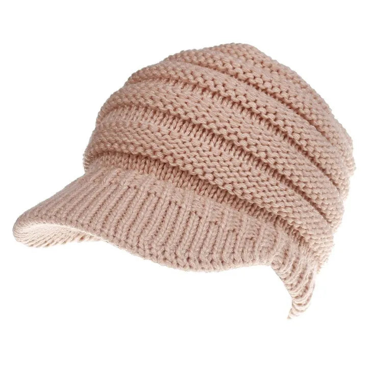 Women's soft acrylic ponytail beanie hat in various colours on a model with a ponytail.