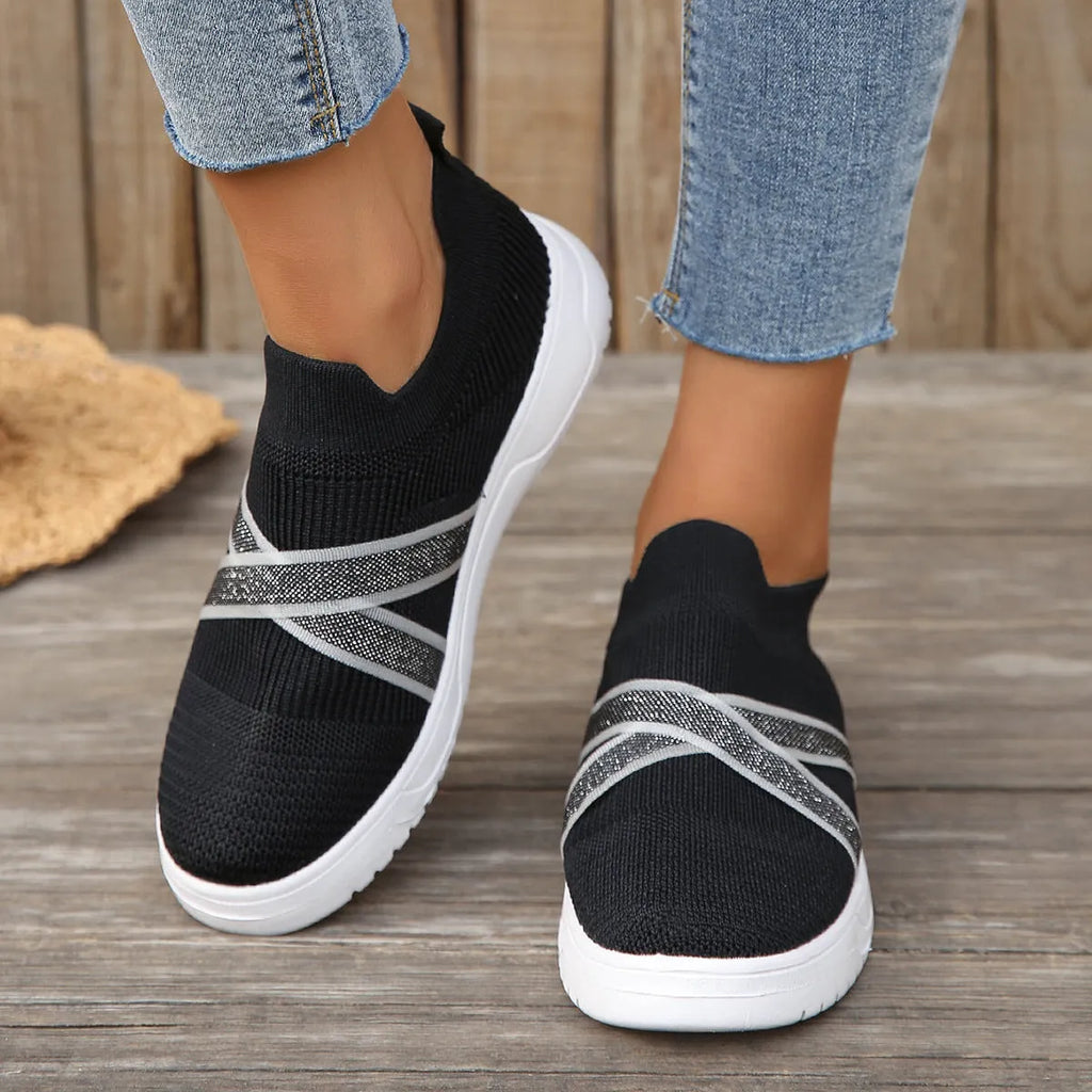 Black women's flyknit mesh casual shoes with flat rubber sole and round toe.