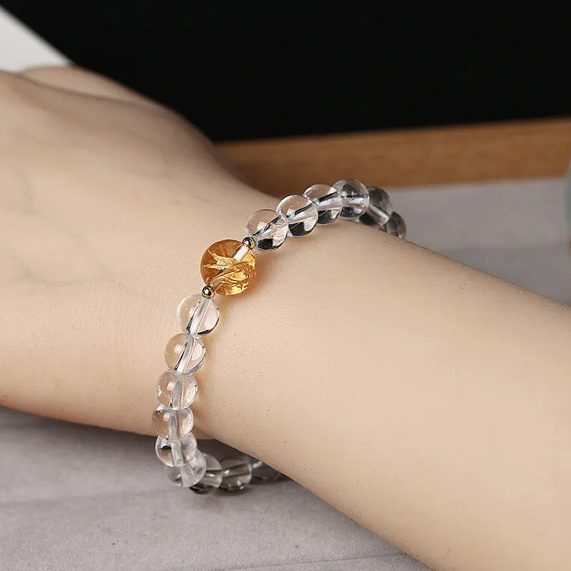 Geometric obsidian black agate white crystal bead bracelet with gold dragon charm on wrist