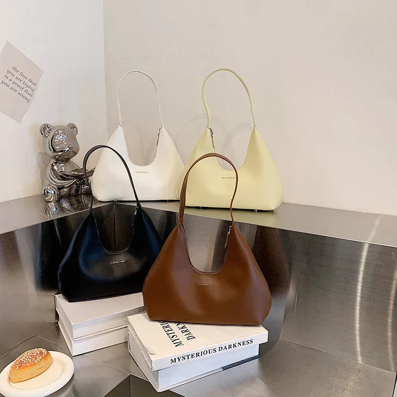 Brown retro PU leather shoulder handbag with a single strap, pillow shape, and stitching detail.