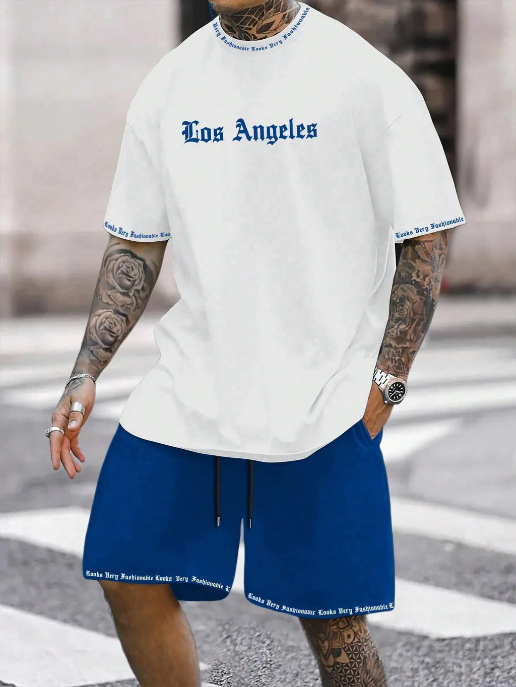 Man wearing a printed short-sleeve top and matching quick-dry sport shorts in a grey colour.