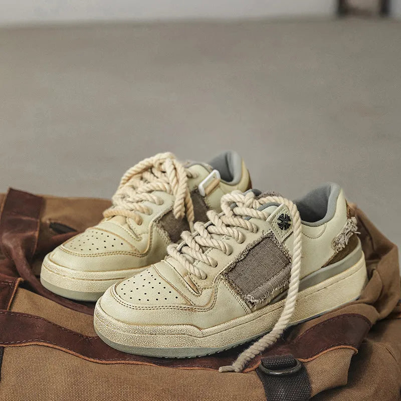 Beige low-top skateboard shoes with microfiber upper and rubber soles on white background