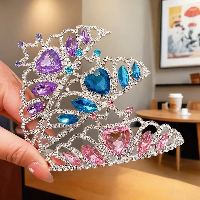 Children's metal headband with crystal crown design in pink, light blue, or light purple.