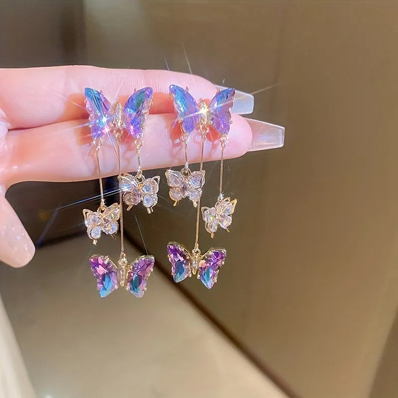 Silver needle blue purple butterfly tassel drop earrings with crystal flower details on alloy.