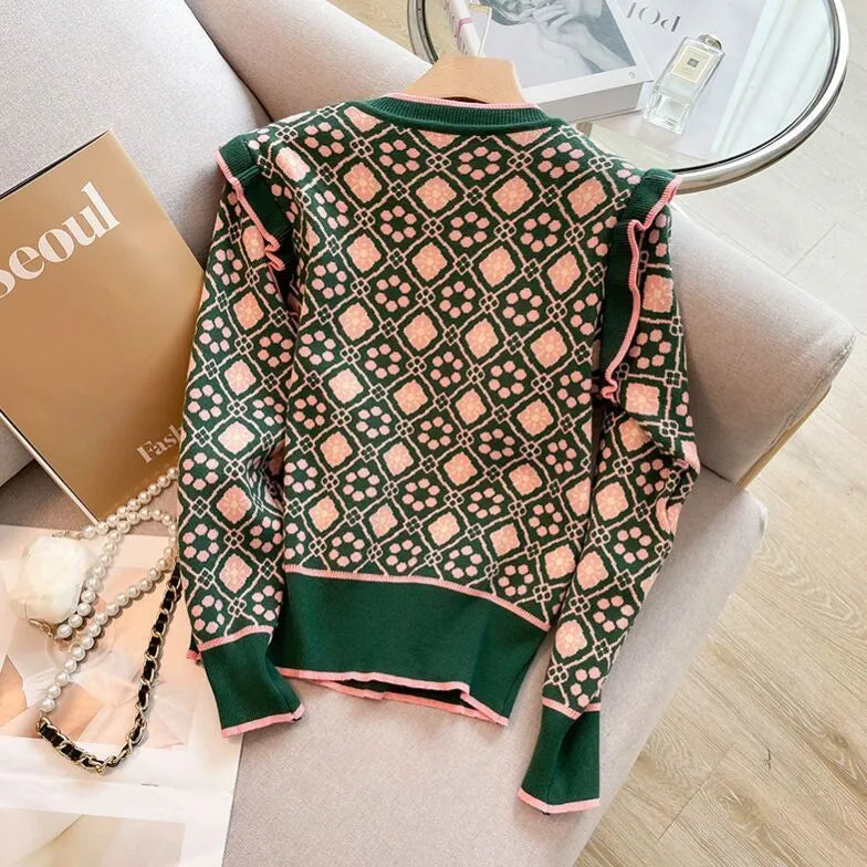 Green women's loose fit printed sweater with regular sleeves on a model.