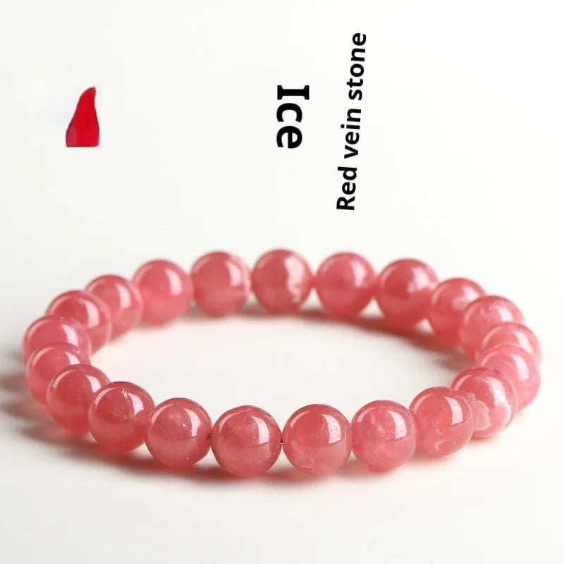 Women's geometric crystal bracelet with rhodochrosite pattern and a longevity lock charm.